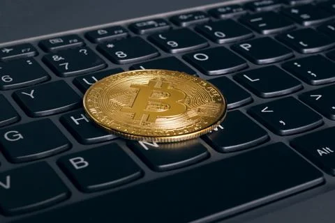 One bitcoins on a computer keyboard closeup Foto stock
