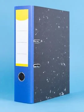 One black office folder isolated on blue, close up Stock Photos
