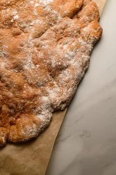 One blank for a multi-layer cake on parchment paper 스톡 사진