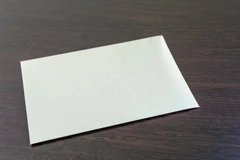 One blank sheet of paper placed horizontally on the dark Stock Photos