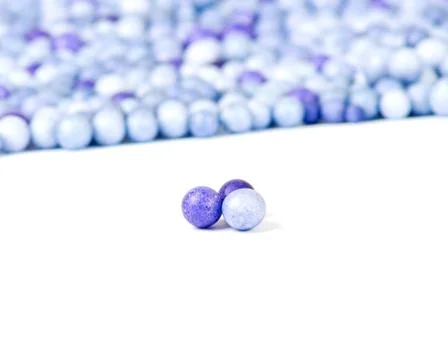 One blue and two violet little pearls Stock Photos