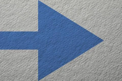One blue arrow on light grey textured background. Pointer Stock Photos