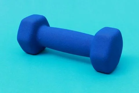 One blue barbell on a blue background Stock Photos