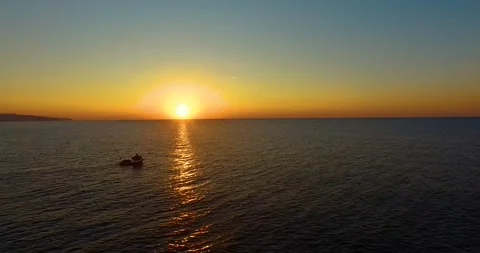 One Boat is Going with Sun Reflection at Sunset, Aerial View 4k Stock Footage 149153069