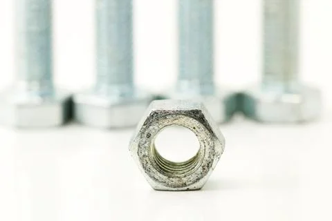 One bolt in front of three 2 Stock Photos