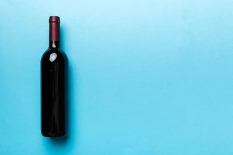 One Bottle of red wine on colored table. Flat lay, top view wth copy space Stock Photos