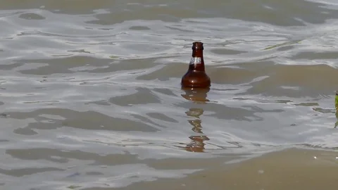 One bottle swims between the waves, 動画素材 104624016