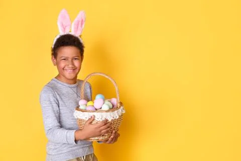 One boy in bunny ears studio isolated on yellow wall easter celebration concept Stock Photos