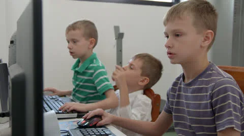 One boy helping another boy on the computer Video stock 22571045