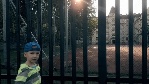 One boy looking at an empty playground Stock Footage 103573092