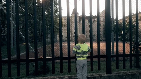 One boy looking at an empty playground Stock Footage 103573159