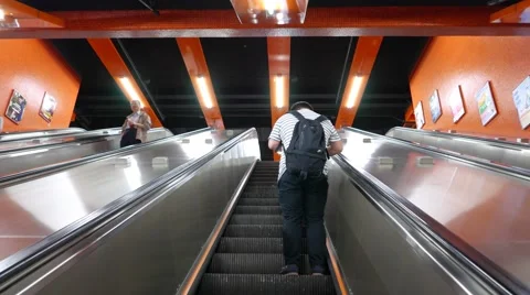 One boy stand at escalator moving up, POV camera looking upwards Video stock 55693922