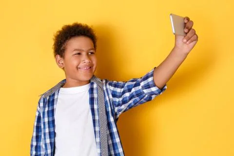 One boy studio isolated on yellow wall taking pictures Stock Photos