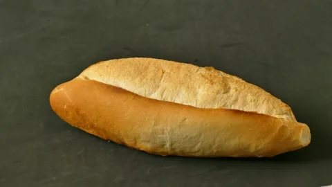 One bread and 10 US dollar bills on it, bread price hike, increased bread p.. Stock Footage 237255223