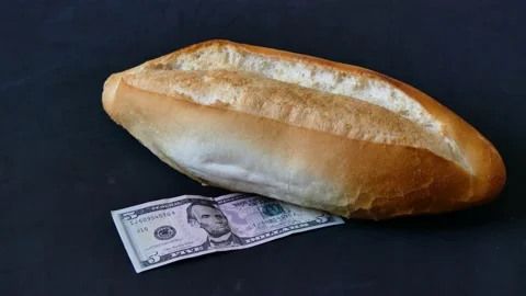 One bread and 5 US dollar on it, bread price hike, increased bread prices, .. Stock Footage 237255384