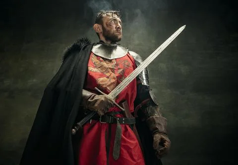 One brutal bearded man, medeival warrior or knight with dirty wounded face Stock Photos