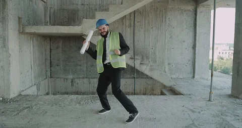 One builder dancing funny in the construction site wearing a hard hat and high Stock Footage 92942270