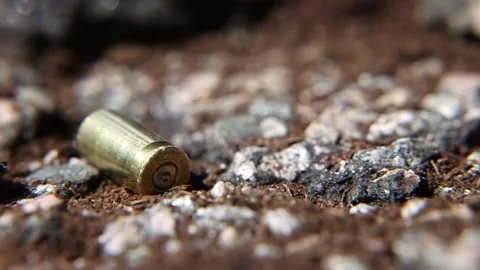 One Bullet Casing (Falling) - Static Shot Stock Footage 196597026