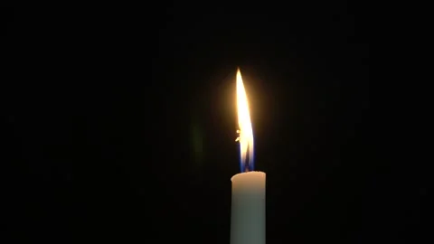 One burning candle on a black background close-up Stock Footage 141091244