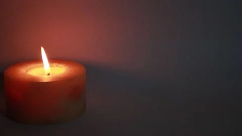One burning candles in the dark Stock Footage