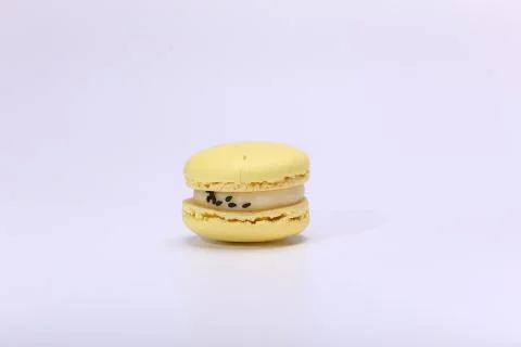One cake of macaron or macaroon yellow lemon color. Delicious macaroon isolated Stock Photos