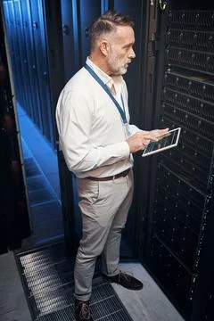 One call and hell have you connected. a mature man using a digital tablet while Foto stock