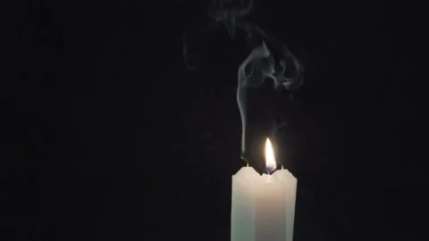 One candle burning, and two extinguished 4K Stock-Footage 101080016