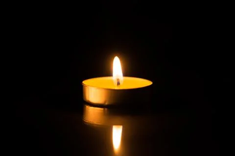 One candle in the dark with reflection Stock Photos