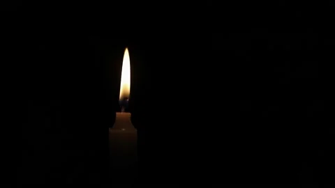 One Candle flame lights isolated on a black background. Stock Footage 223824258