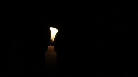 One Candle flame lights isolated on a black background. Stock Footage 230062279