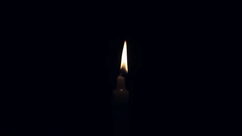 One Candle flame lights isolated on a black background. Stock Footage 245569939