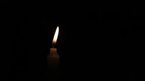 One Candle flame lights isolated on a black background. Stock Footage 303766983