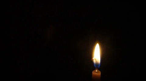 One candle flame at night closeup - isolated Stock Footage 33075422