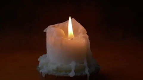 One candle on isolated dark background. blowing candle Stock Footage 295980762