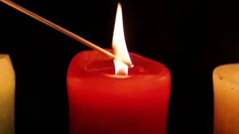 One candle is lit from the fire of another candle Stock Footage 83416212