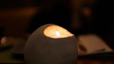 One candle in original shape candlestick at night closeup Stock Photos
