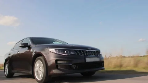 One car is driving along the asphalt road next to us. Stock Footage 224679989