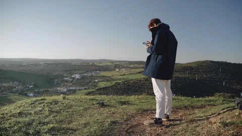 One Caucasian man taking off this drone from the ground Stock Footage 240397429