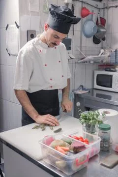 One chef kitchen cutting pickles Stock Photos
