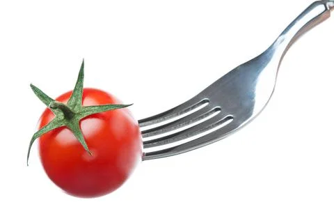 One cherry tomato on a fork over white background Stock Photos