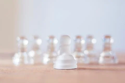 One chess piece alone against set of chess pieces Stock Photos