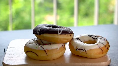 One Chocolate and Two White Frosted Donuts on Tray - Unhealthy Diet Stock Footage 105782916