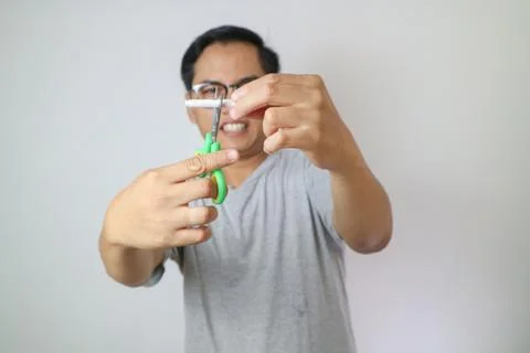 One cigarette through the blades of a scissors for kids. white and blue col.. Stock Photos