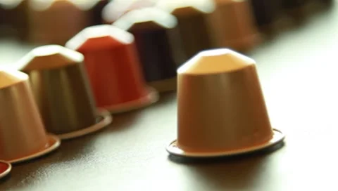 One coffee capsule coming into frame Stock Footage 8913565