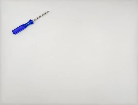 One colored screwdriver with blue plastic handle on the left top on a white Stock Photos