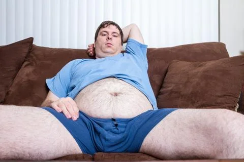 One comfortable guy sitting on the couch. Stock Photos