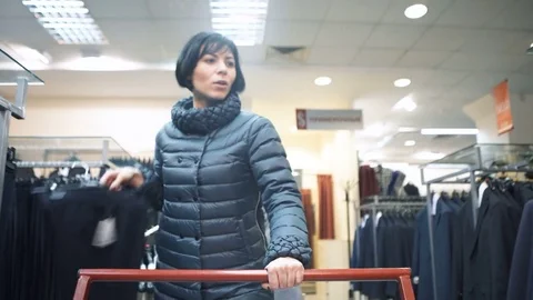 One consumer walk and choose cloth, put in car Stock Footage 79249731