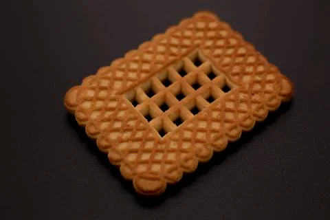 One cookie on a dark background Stock Photos