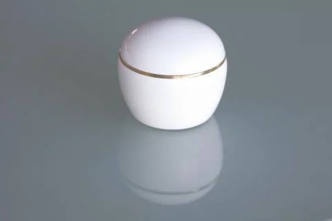 One cosmetic container on the glass surface Foto stock
