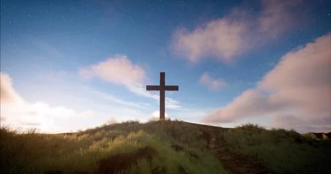 One cross on the hill with clouds moving on blue starry sky Фото